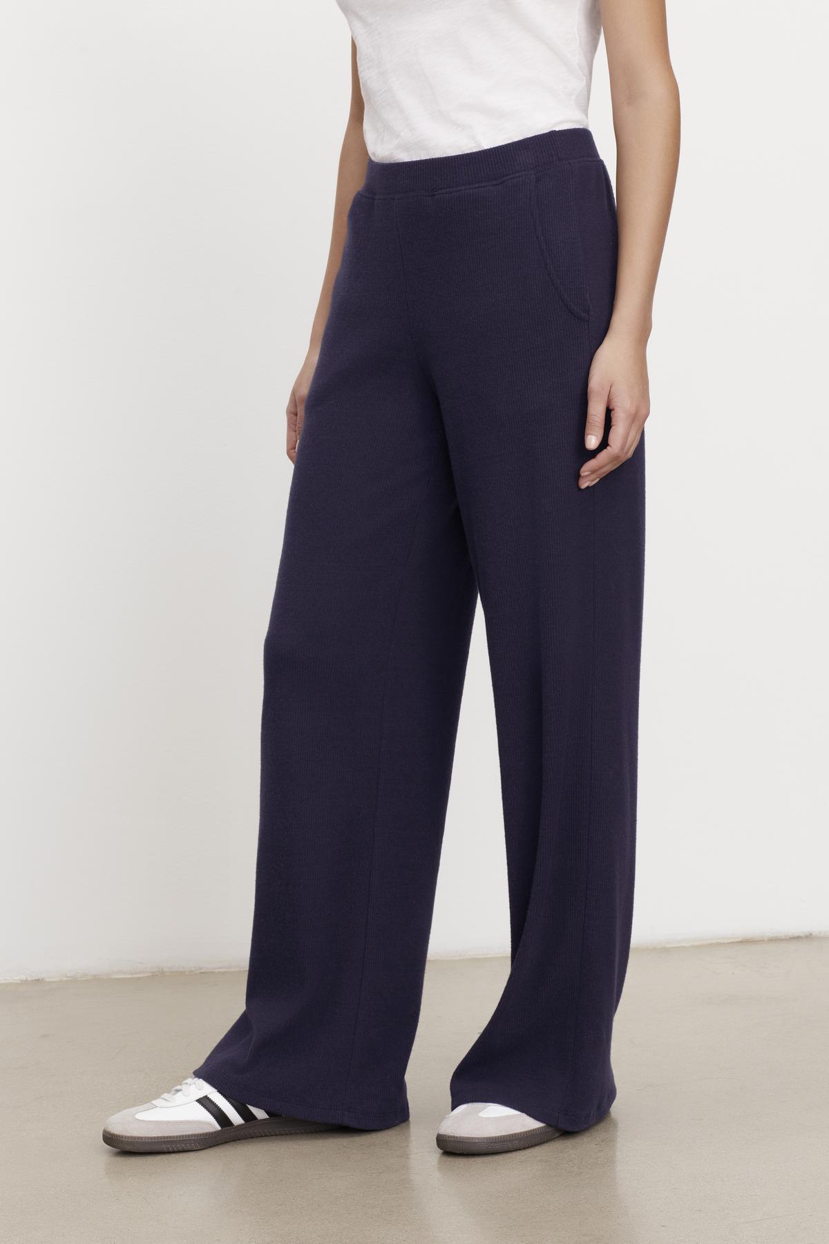   A woman wearing a Velvet by Graham & Spencer KACIE BRUSHED RIB PANT and white t-shirt. 