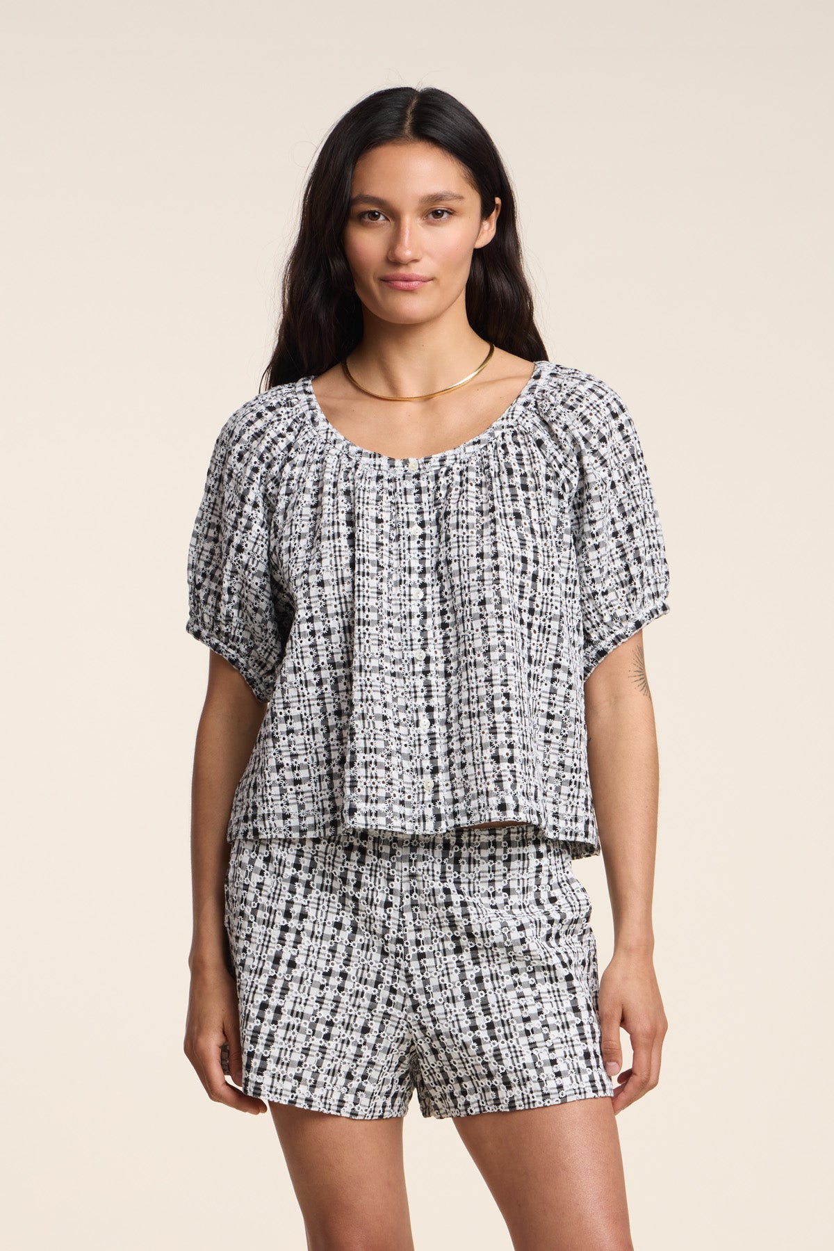 Model wearing the ANGIE TOP by Velvet by Graham & Spencer—a black-and-white gingham set—standing against a plain light background.-41526918578369