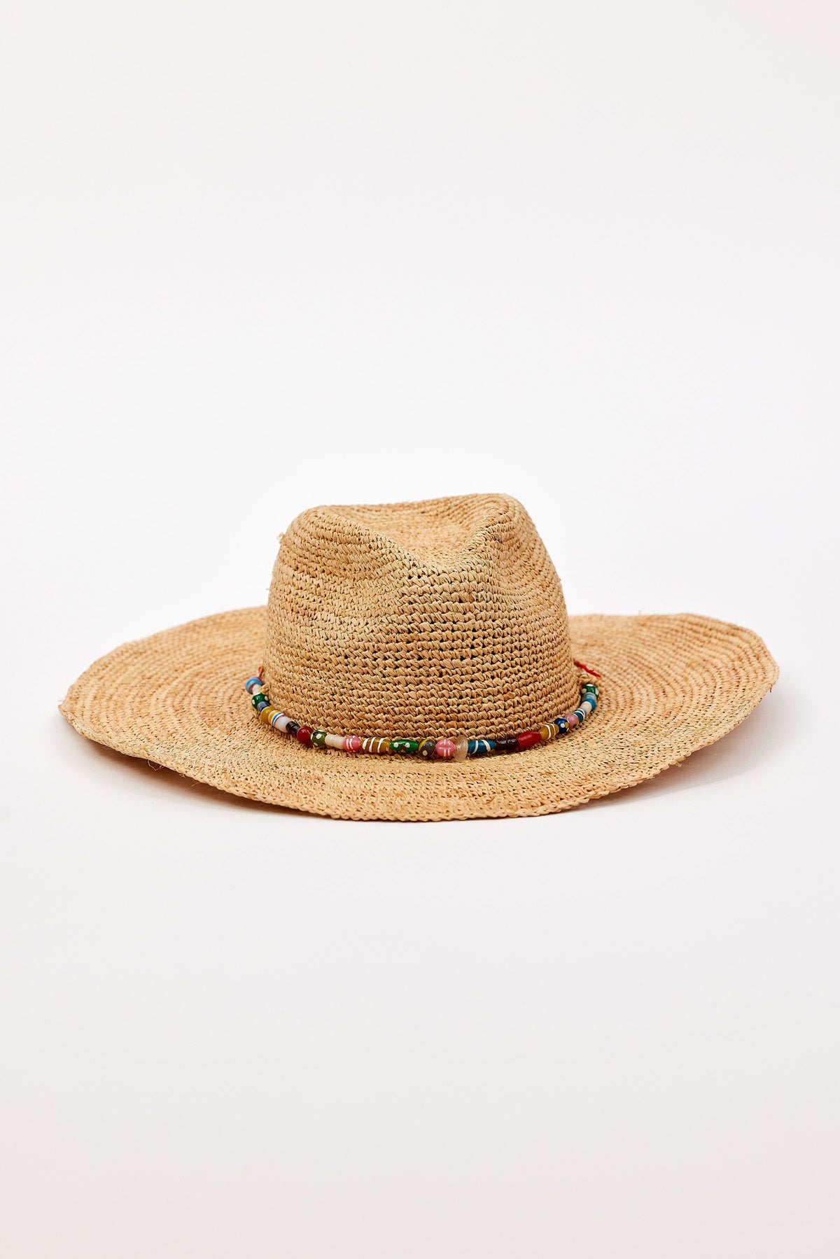 The MILLIE CONTINENTAL HAT by Velvet by Graham & Spencer features a woven straw design, wide brim, and colorful beaded band, shown against a plain white background.