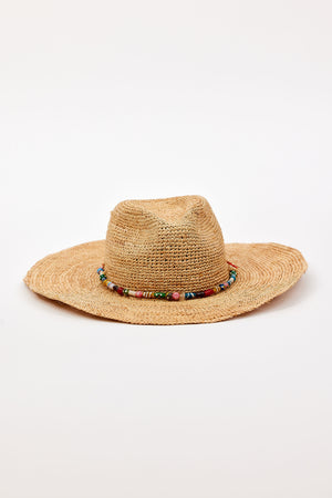 The MILLIE CONTINENTAL HAT by Velvet by Graham & Spencer features a woven straw design, wide brim, and colorful beaded band, shown against a plain white background.
