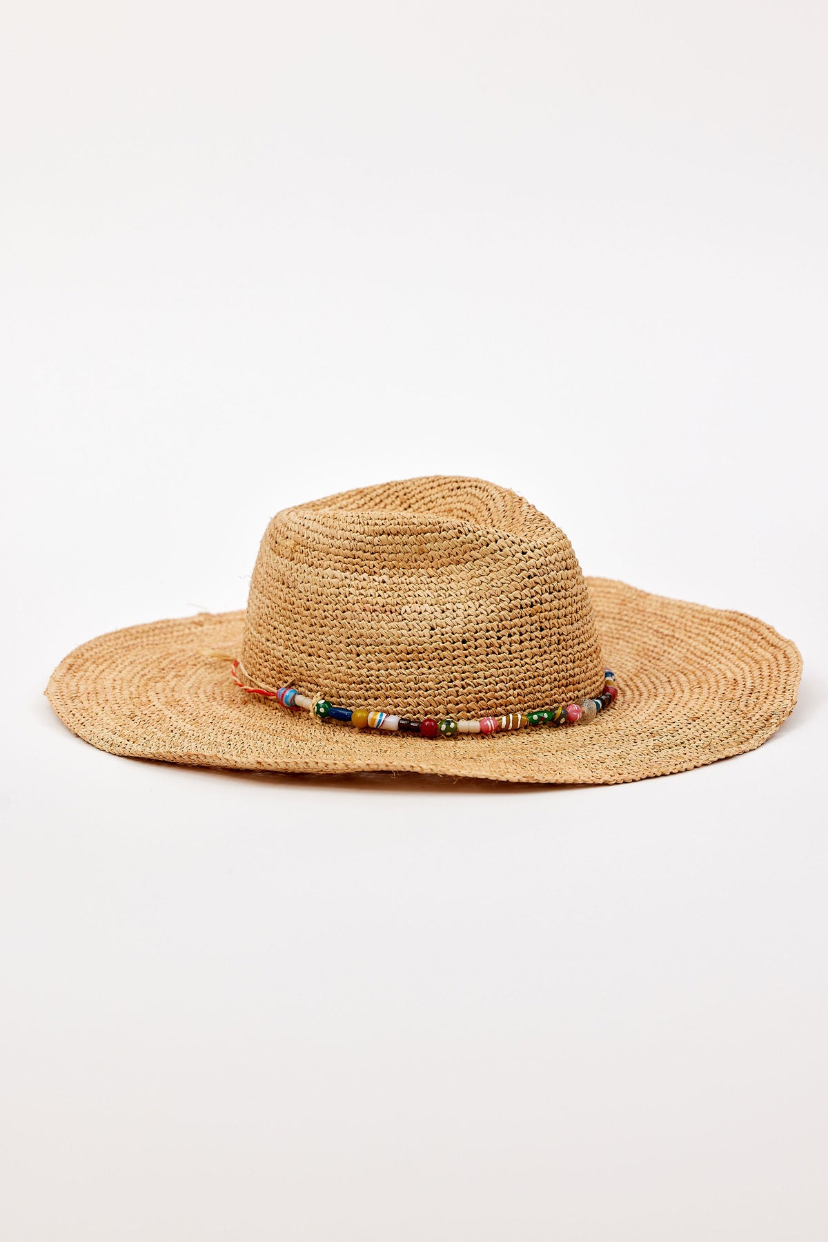 The MILLIE CONTINENTAL HAT by Velvet by Graham & Spencer is a wide-brimmed woven straw hat featuring a beaded band around the crown, shown against a plain white background.-41332170784961