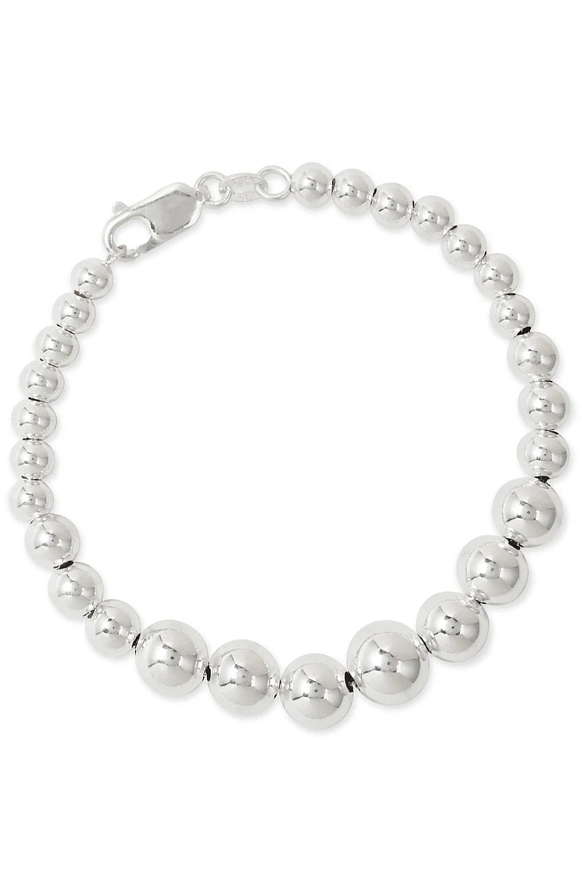 Close-up of The Graduate Bracelet by Phyllis and Rosie, showing polished silver spherical beads and lobster clasp