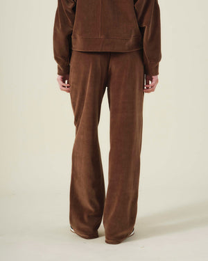 Rear view of a person wearing brown DAISY VELOUR TRACK PANT and a matching plush, long-sleeved top.