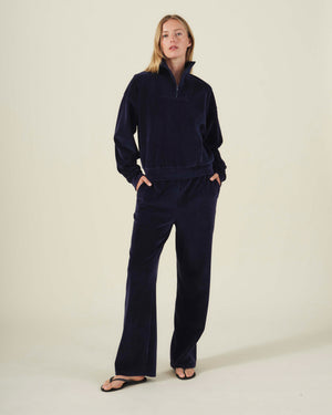 Person wearing a dark navy DANICA VELOUR HALF-ZIP SWEATSHIRT and matching wide-leg pants.