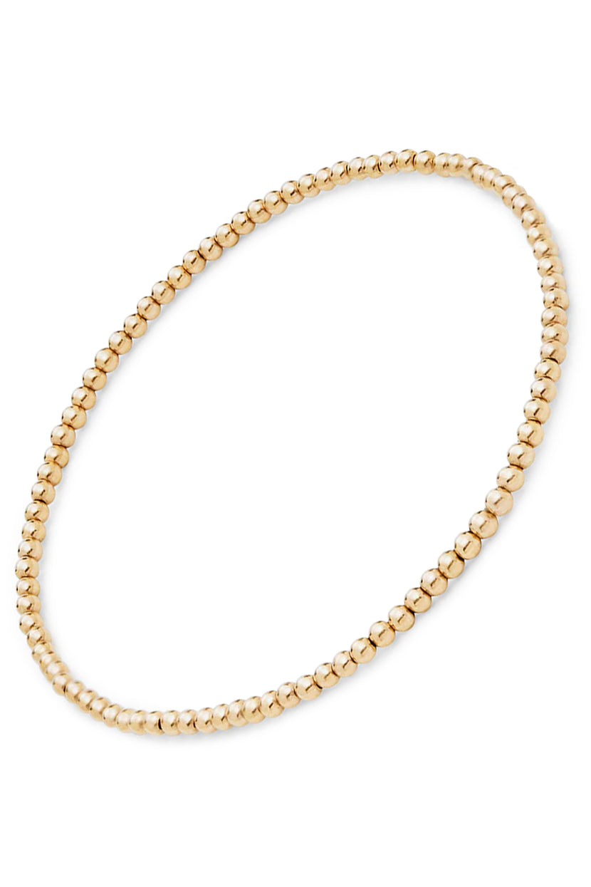 Top view of Mini Moon Bracelet by Phyllis and Rosie showcasing small round gold beads on a white background