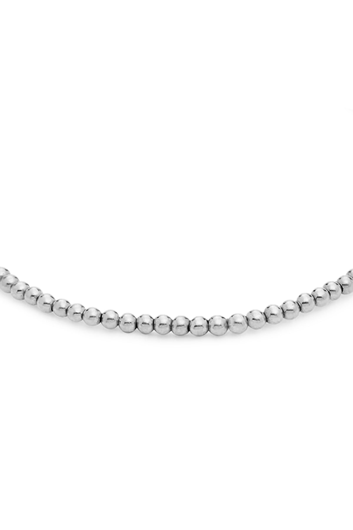 A close-up view of the MINI MOON BRACELET BY PHYLLIS+ROSIE, a hand crafted beaded bracelet with spherical silver beads inspired by vintage street culture in New York City.-37832678867137