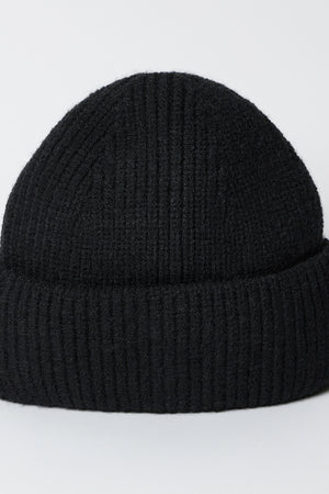 The MAJOR BEANIE by Velvet by Graham & Spencer, a black ribbed-knit hat with a classic cuffed design, is showcased against a simple white background. Ideal for winter weather, this unisex beanie blends style and warmth seamlessly.