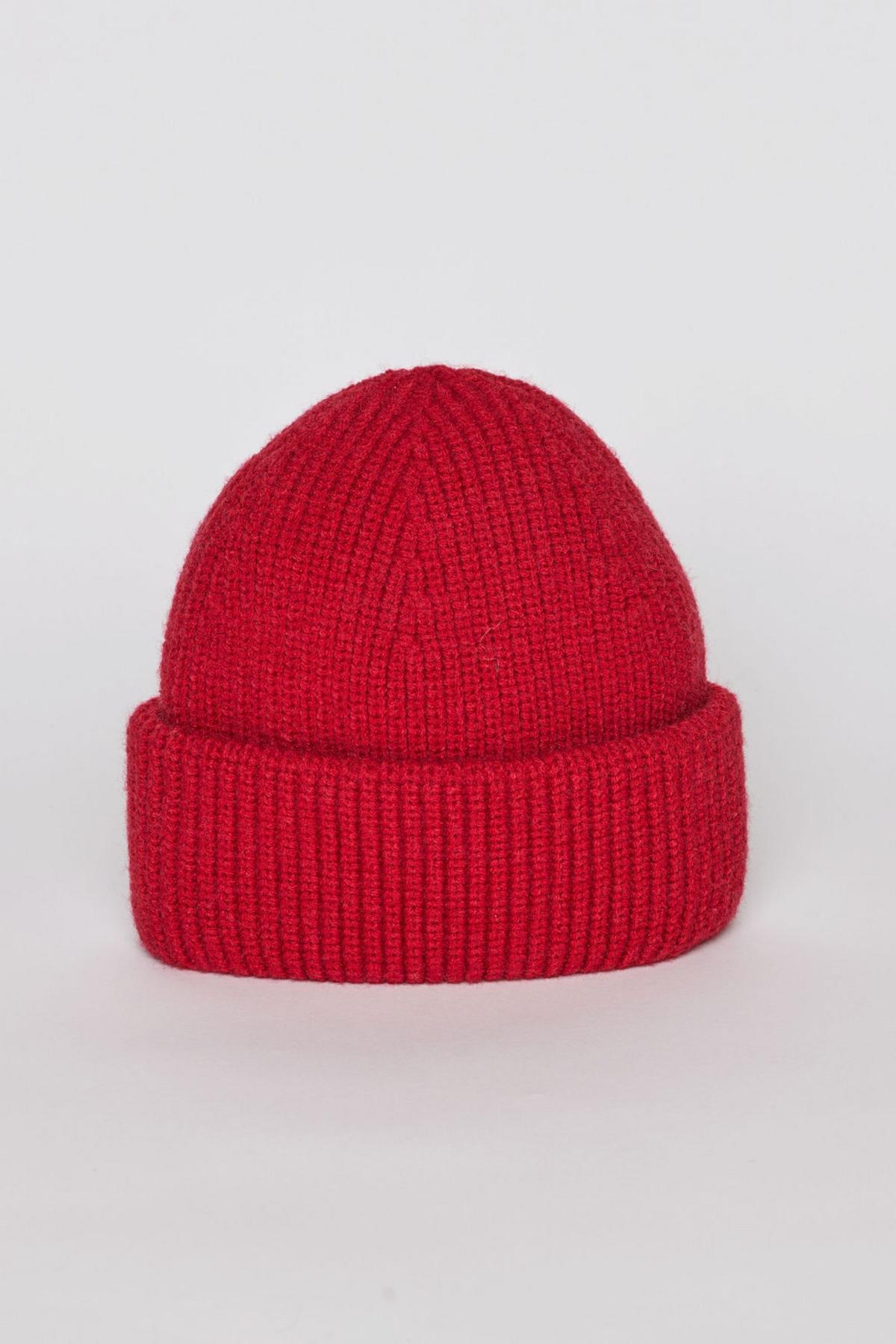   The MAJOR BEANIE by Velvet by Graham & Spencer features a knitted red design with a folded brim, presented stylishly against a plain white background, making it ideal for winter weather. 