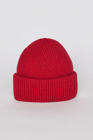 The MAJOR BEANIE by Velvet by Graham & Spencer features a knitted red design with a folded brim, presented stylishly against a plain white background, making it ideal for winter weather.