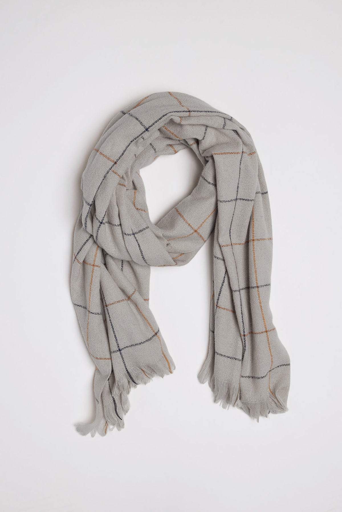   Introducing the HUDSON WINDOWPANE SCARF by Velvet by Graham & Spencer – a light gray scarf adorned with a sophisticated grid pattern of thin black and orange lines, complete with elegant fringed edges, all displayed on a pristine white background. 