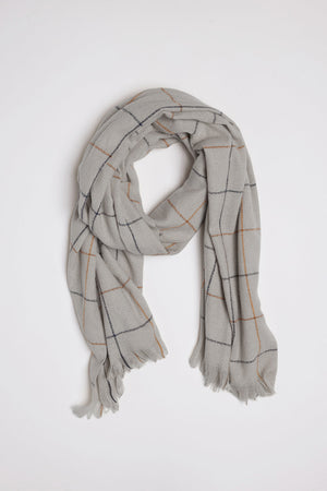 Introducing the HUDSON WINDOWPANE SCARF by Velvet by Graham & Spencer – a light gray scarf adorned with a sophisticated grid pattern of thin black and orange lines, complete with elegant fringed edges, all displayed on a pristine white background.