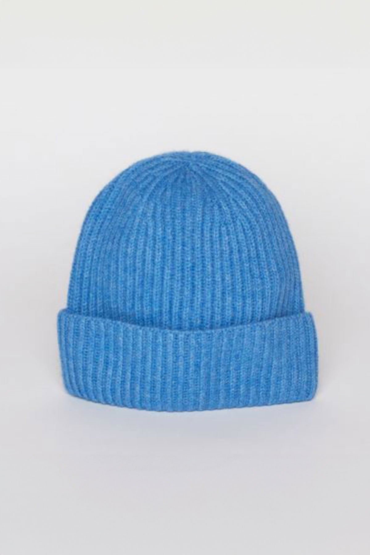   The CASHMERE RIB BEANIE by Velvet by Graham & Spencer, featuring a folded brim in a striking blue knit, is displayed against a plain white background. 