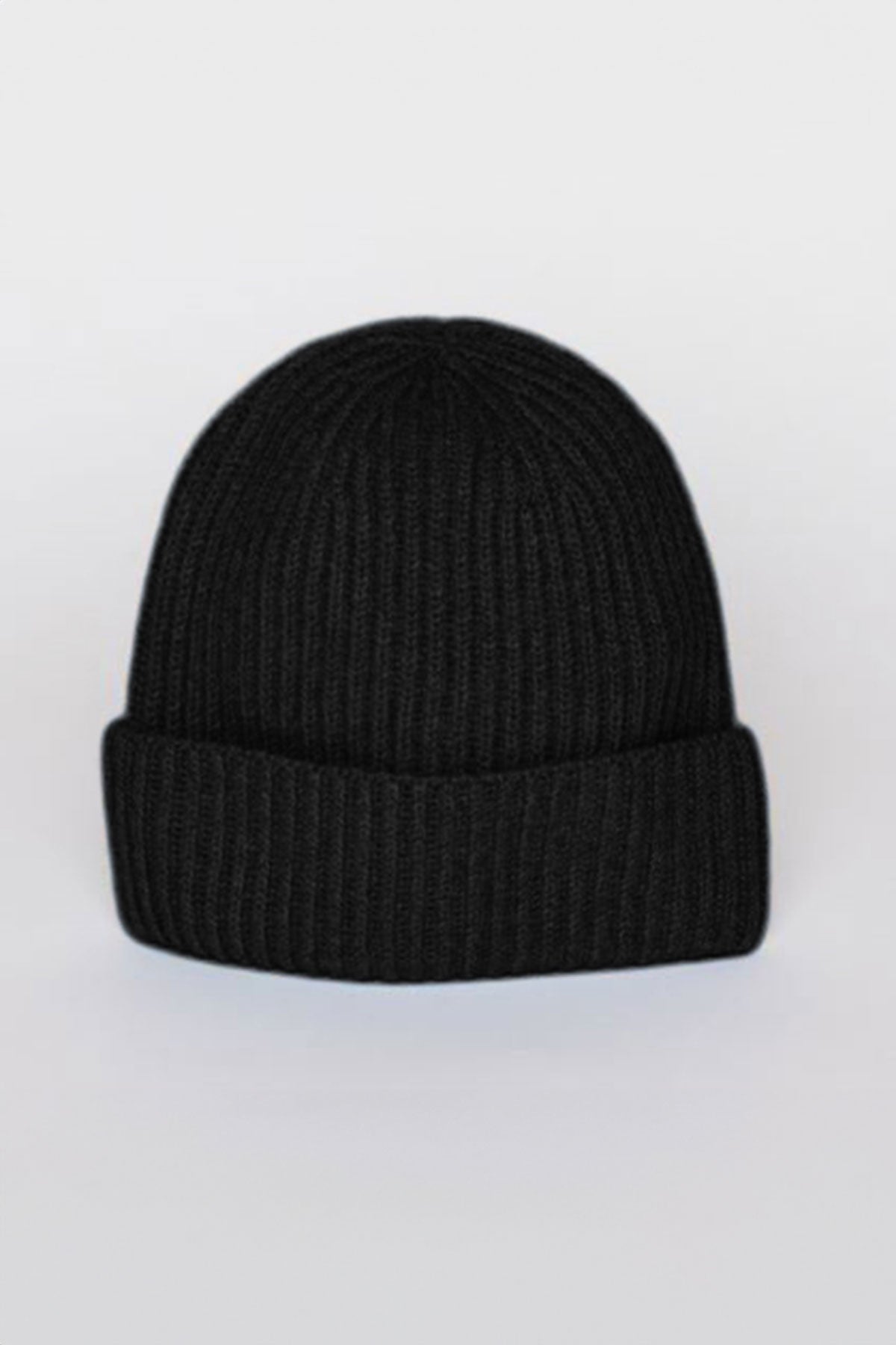   The CASHMERE RIB BEANIE by Velvet by Graham & Spencer, a versatile black knit hat with a ribbed design, is displayed against a light gray background. 