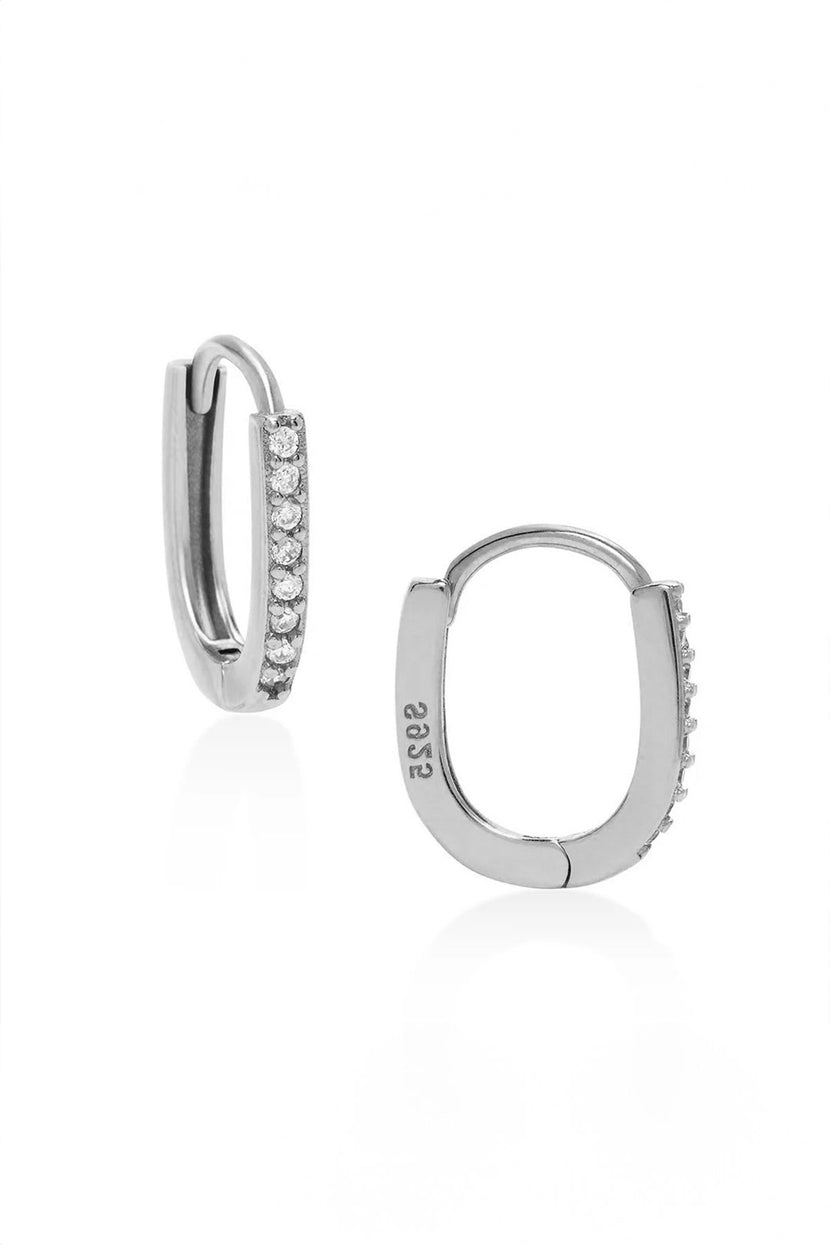 Front and side view of Oblong Pave Huggies by Phyllis and Rosie showcasing silver hoops with pave stones on a white background