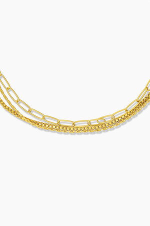 A Rosalie Triple Strand Bracelet by Thatch with a gold plated chain.