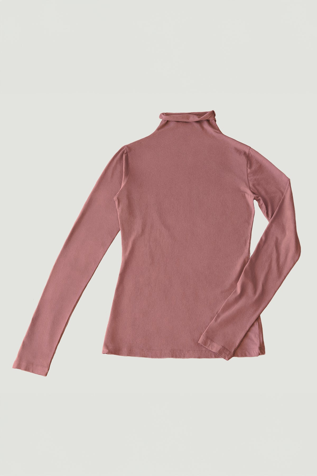   The TALISIA TEE by Velvet by Graham & Spencer is a fashionable pink long-sleeve mock neck shirt with a plain design, laid flat against a white background. This versatile wardrobe staple is perfect for any occasion. 