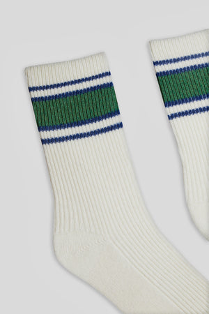 A pair of ATHLEISURE CASHMERE CREW SOCKS by Hansel From Basel, featuring a dynamic white design with green and blue stripes near the top, perfectly embodying the vibrant aesthetic signature of Hansel from Basel's legwear collection.