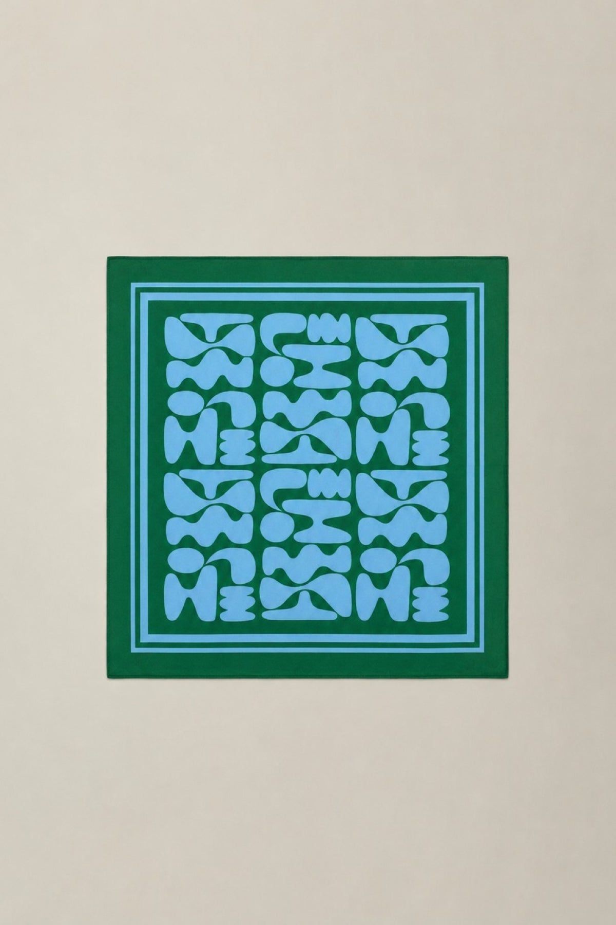 Blue geometric pattern with a green border scarf against a beige background-41645284556993