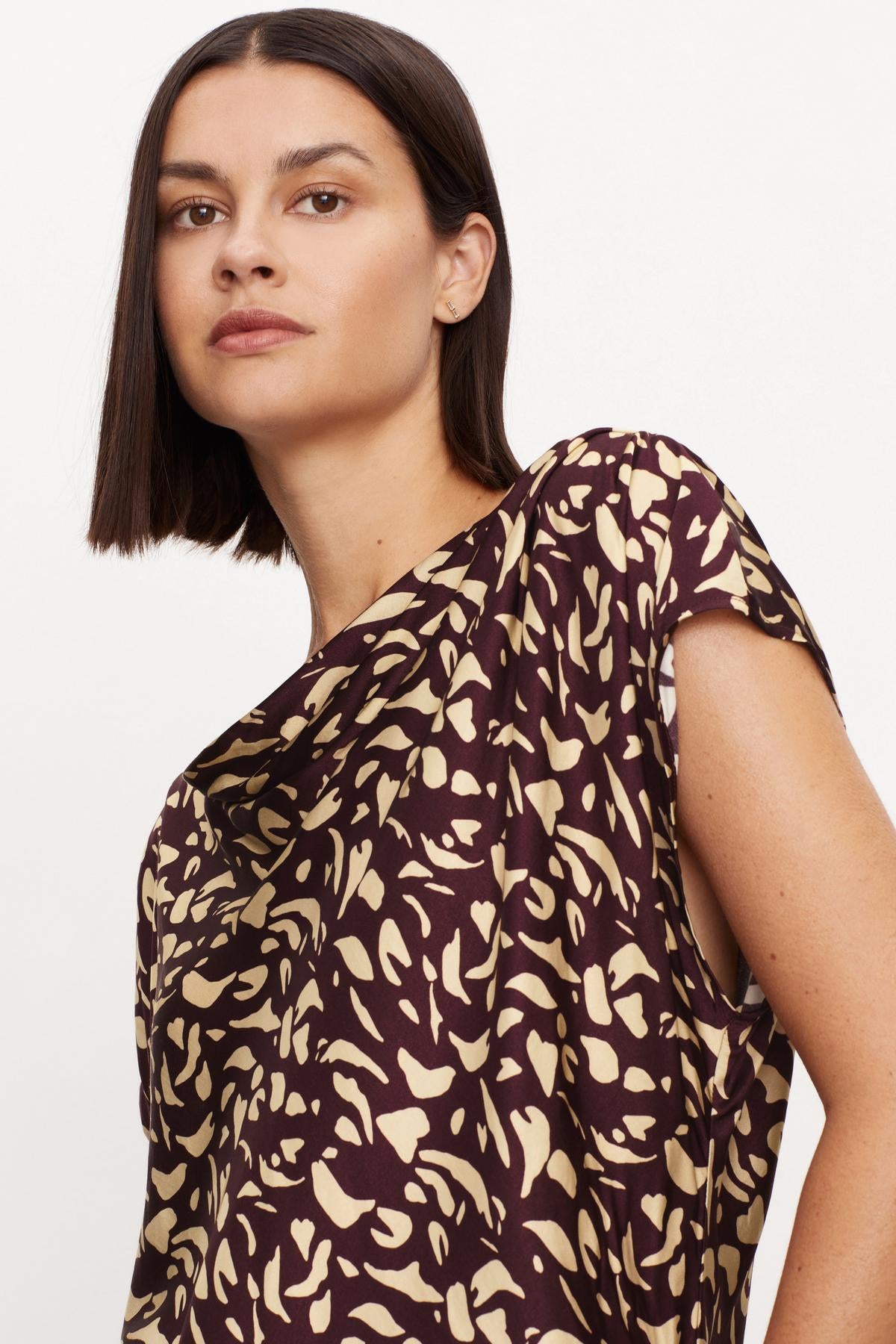   The model is wearing a DEVI PRINTED SATIN BLOUSE by Velvet by Graham & Spencer. 