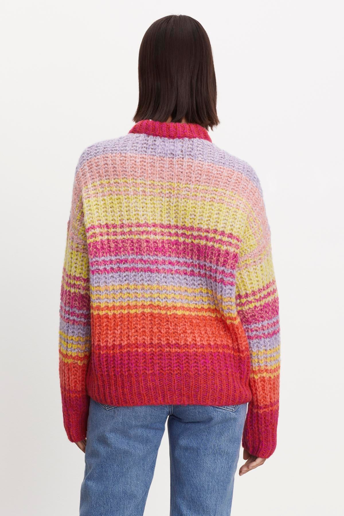   The view of a woman wearing a Velvet by Graham & Spencer Brandy Striped Crew Neck Sweater is cozy and comforting. 