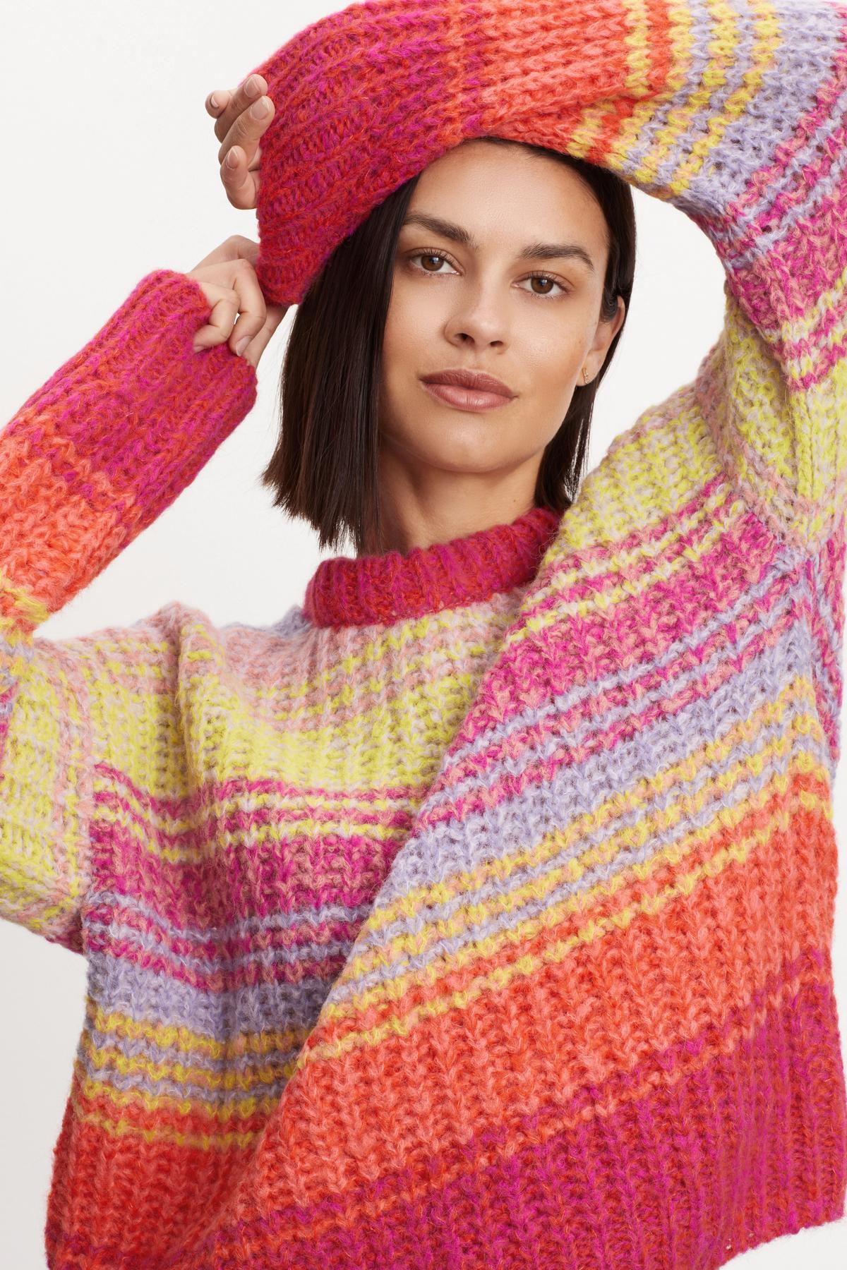 A cozy model wearing a Velvet by Graham & Spencer Brandy Striped Crew Neck Sweater.-35624145191105