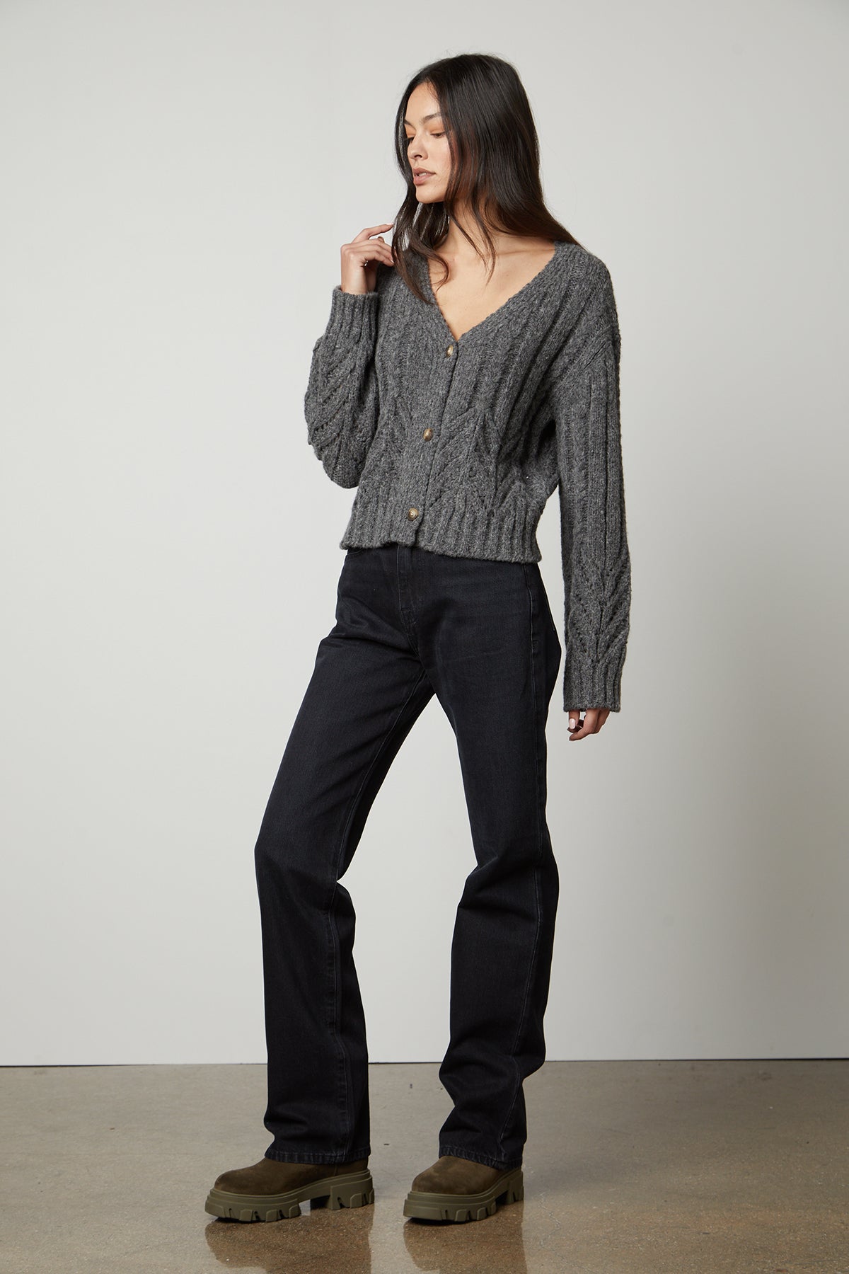 The model is wearing a HAZEL ALPACA cable knit cardigan by Velvet by Graham & Spencer with pointelle detailing and black pants.-35503613182145