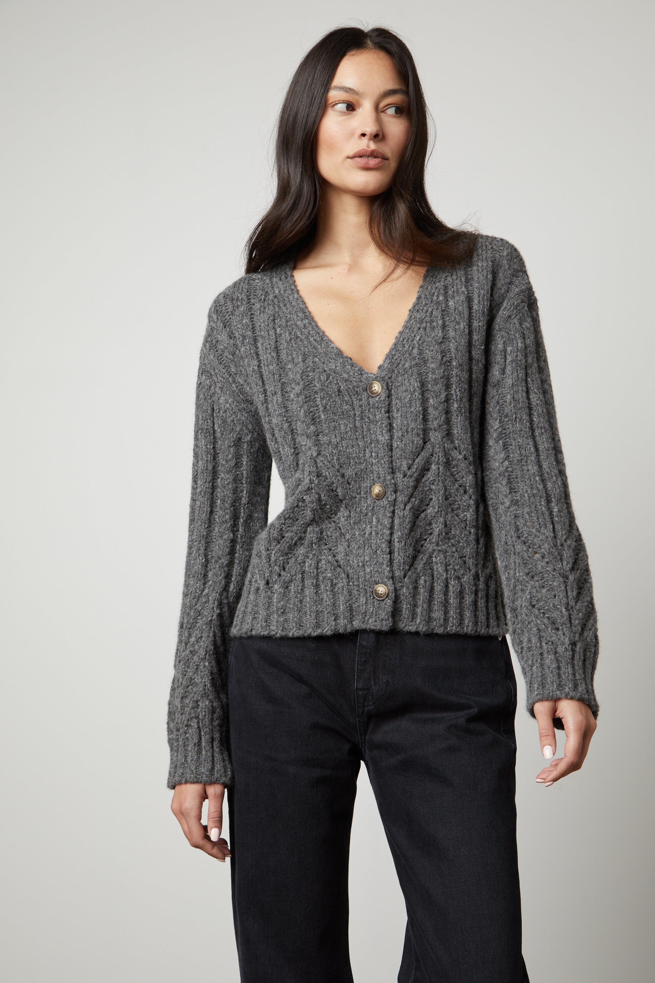   The model is wearing a Velvet by Graham & Spencer Hazel Alpaca Cable Knit Cardigan. 