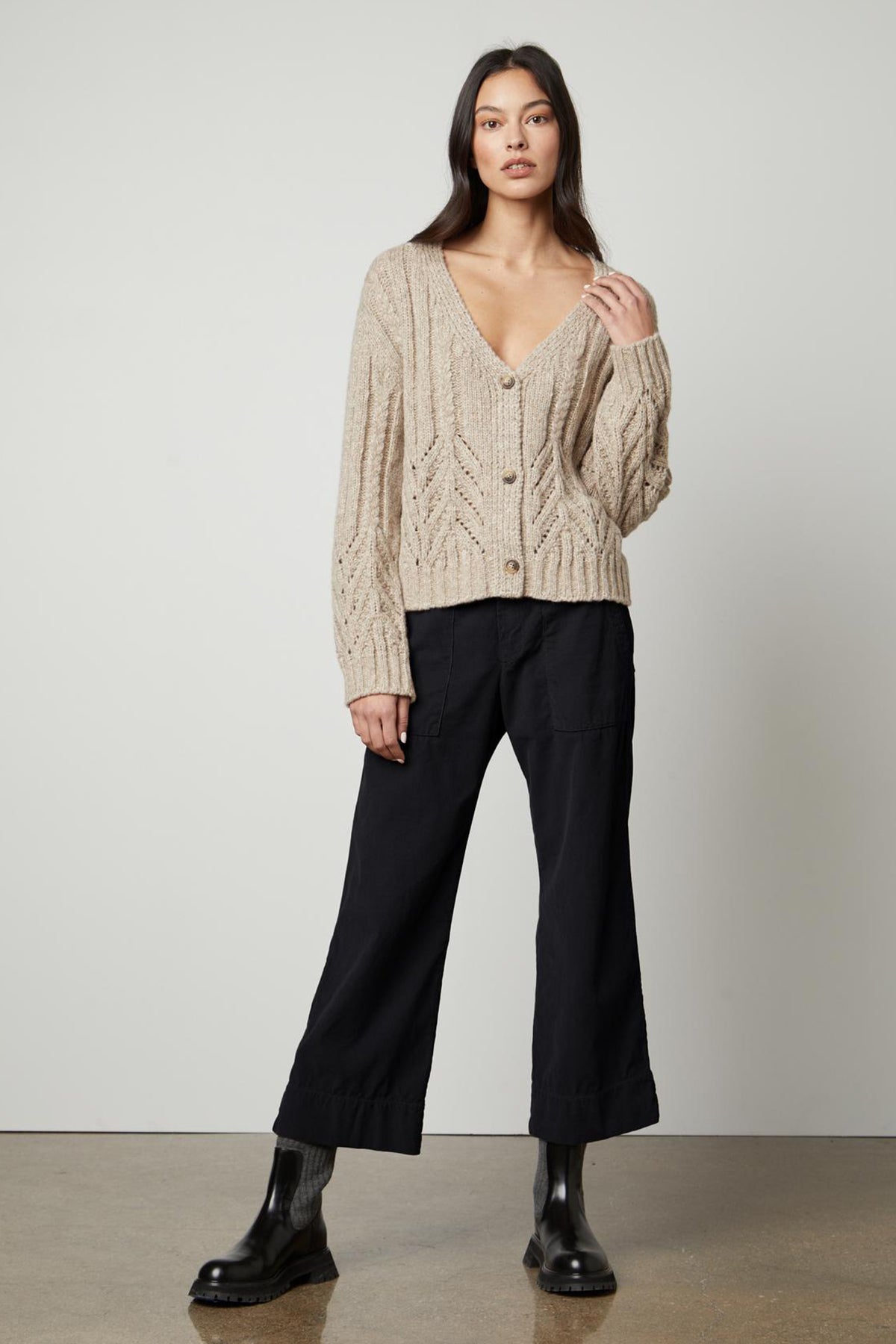 The model is wearing a beige HAZEL ALPACA CABLE KNIT CARDIGAN and black wide leg pants from Velvet by Graham & Spencer.-26897822318785