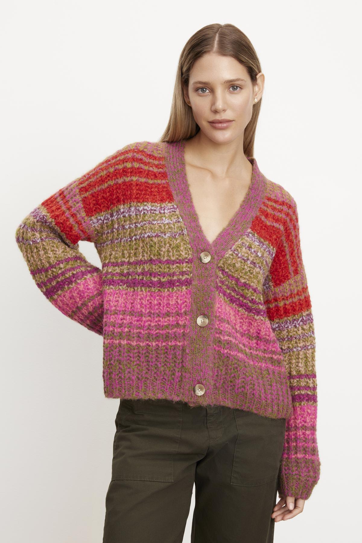   A woman is wearing an EDDIE striped cardigan by Velvet by Graham & Spencer. 