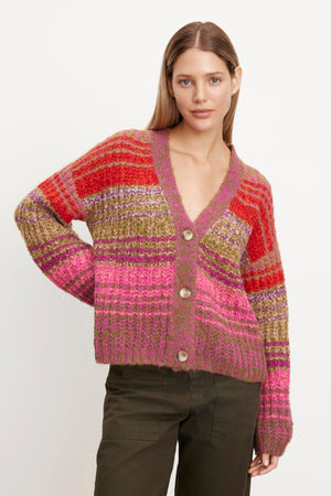 A woman is wearing an EDDIE striped cardigan by Velvet by Graham & Spencer.
