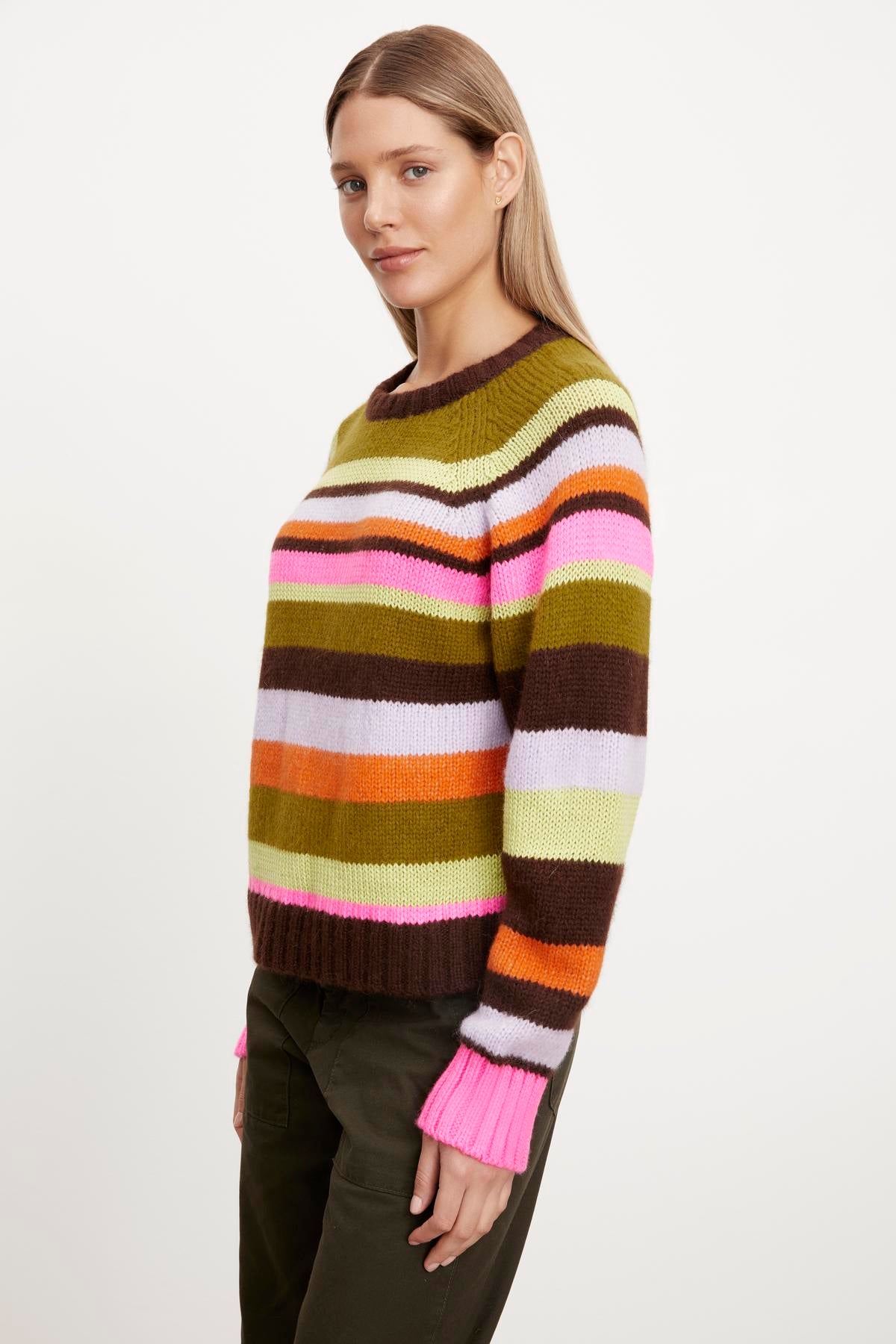 A woman wearing a Velvet by Graham & Spencer NESSIE STRIPED CREW NECK SWEATER made from an alpaca blend fabric.-35654464831681
