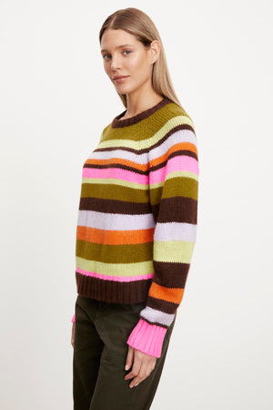 A woman wearing a Velvet by Graham & Spencer NESSIE STRIPED CREW NECK SWEATER made from an alpaca blend fabric.