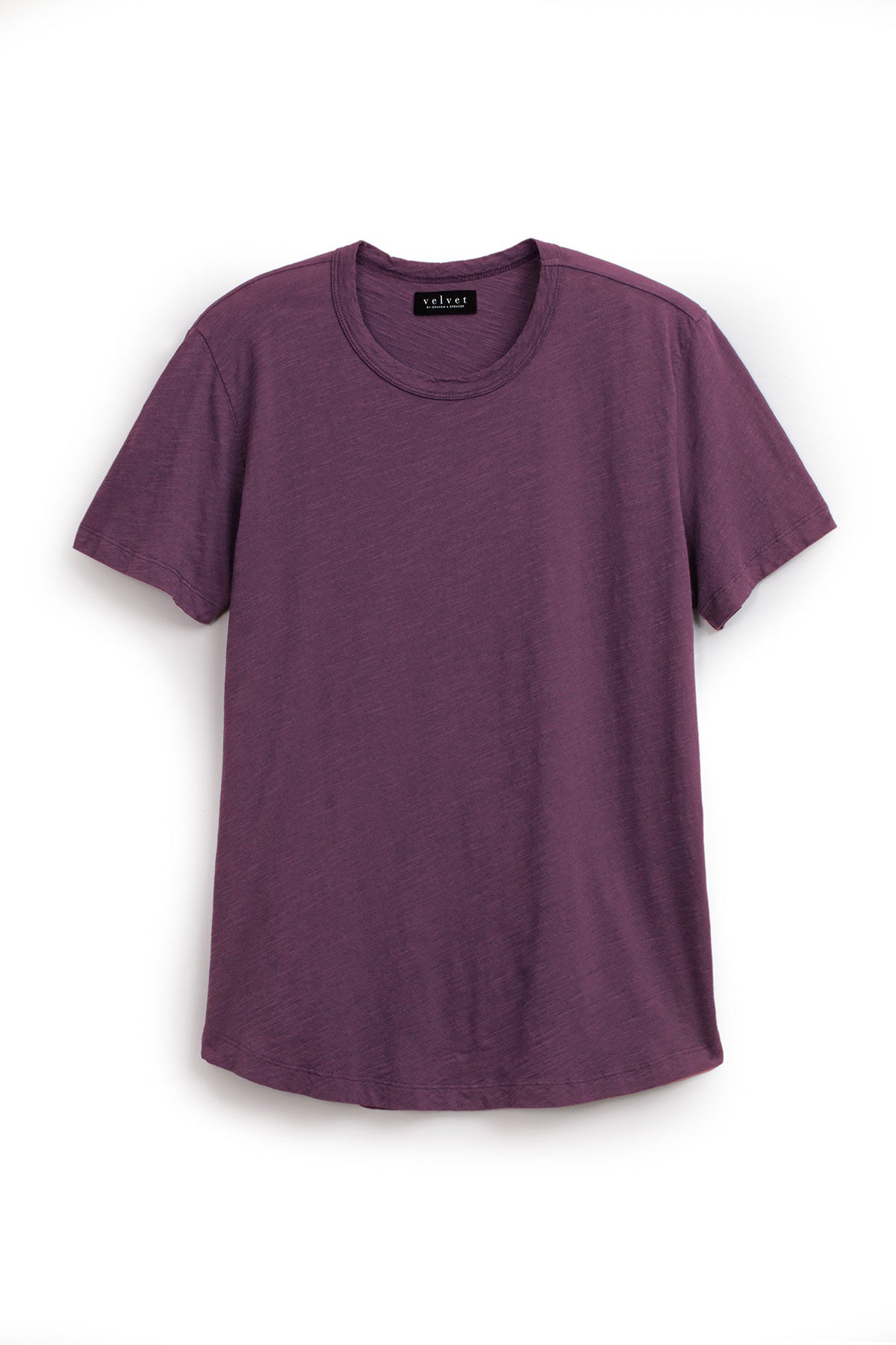   The AMARO TEE by Velvet by Graham & Spencer is a purple short-sleeve T-shirt made from luxurious Peruvian cotton. It features a classic crew neckline, ideal as a layering piece on a white background. 