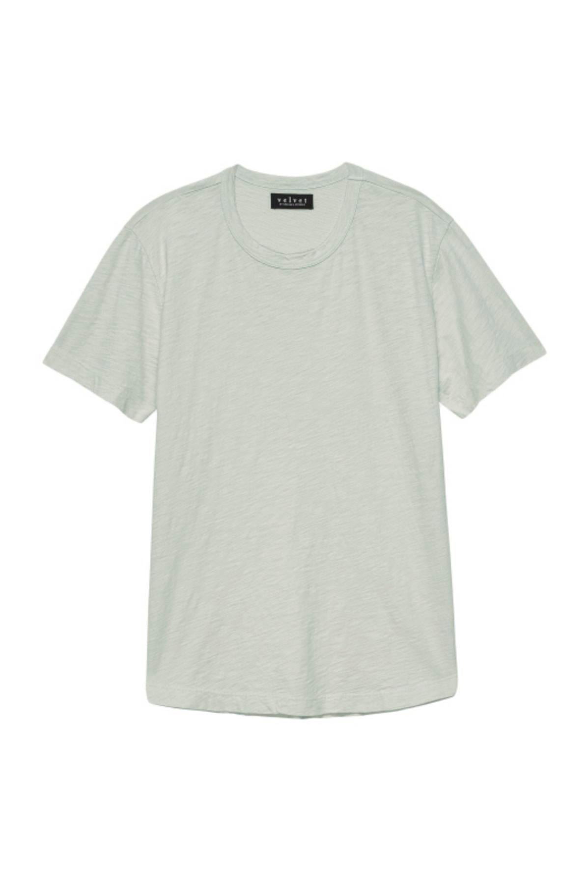 The AMARO TEE by Velvet by Graham & Spencer is a plain, light green short-sleeve T-shirt with a classic crew neckline and a black tag at the back of the collar. Made from lightweight Peruvian cotton, it offers a comfortable fit and a polished finish.-37682019500225