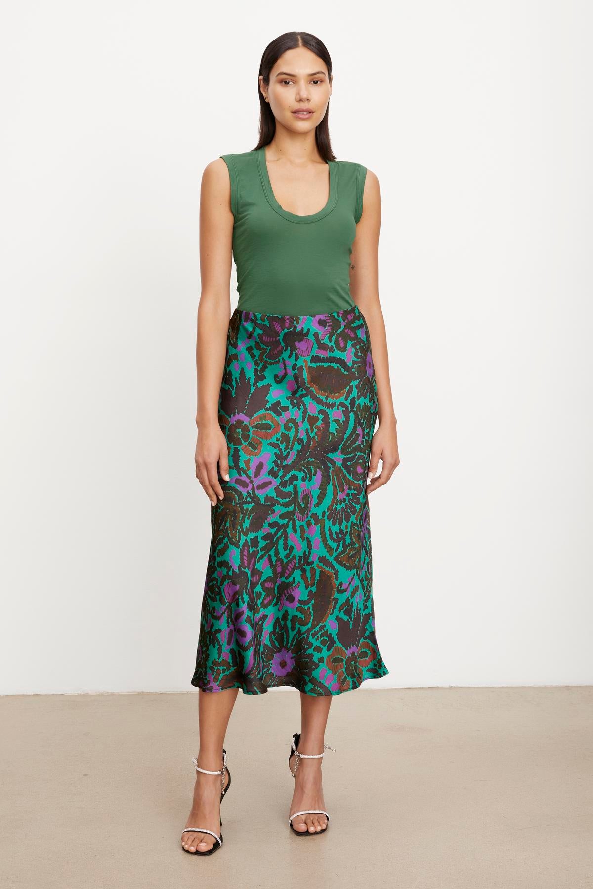 The model is wearing a green top and a KAIYA PRINTED SKIRT by Velvet by Graham & Spencer with an elastic waist for a comfortable fit.-36094331060417