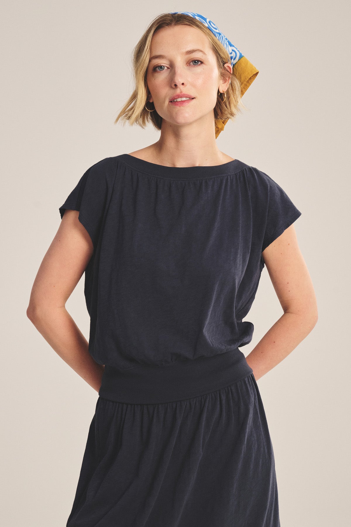 Woman wearing the AUDEN TEE by Velvet by Graham & Spencer, styled for everyday wear with a patterned headscarf, standing with hands behind her back against a plain background.-41296654860481