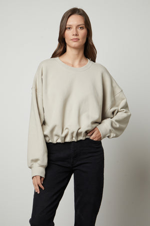 The model is wearing a Velvet by Graham & Spencer BOBBI CROPPED SWEATSHIRT.