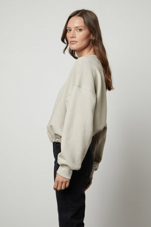 The model is wearing a Velvet by Graham & Spencer BOBBI CROPPED SWEATSHIRT.