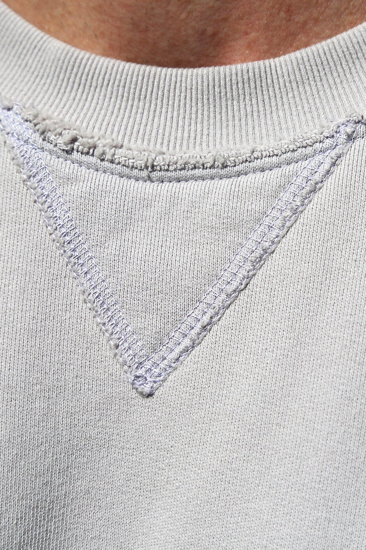 Close-up of the FORREST SWEATSHIRT neckline from Velvet by Graham & Spencer, showcasing a V-shaped stitch design and ribbed trims for added detail in light gray.-38325935243457