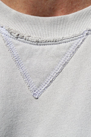 Close-up of the FORREST SWEATSHIRT neckline from Velvet by Graham & Spencer, showcasing a V-shaped stitch design and ribbed trims for added detail in light gray.