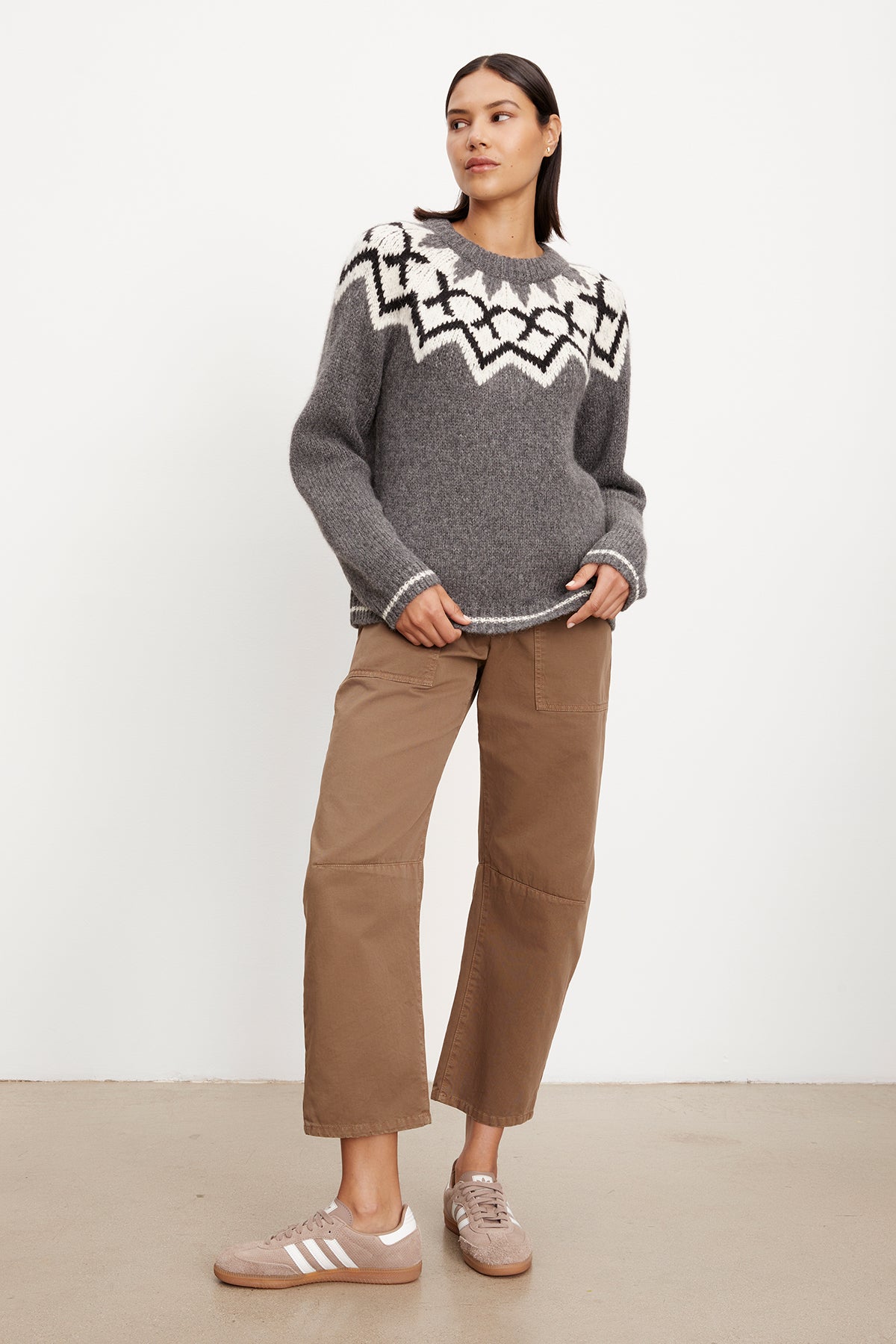   The model is wearing a grey Velvet by Graham & Spencer Alexa Fair Isle Crew Neck sweater. 