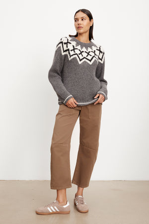 The model is wearing a grey Velvet by Graham & Spencer Alexa Fair Isle Crew Neck sweater.