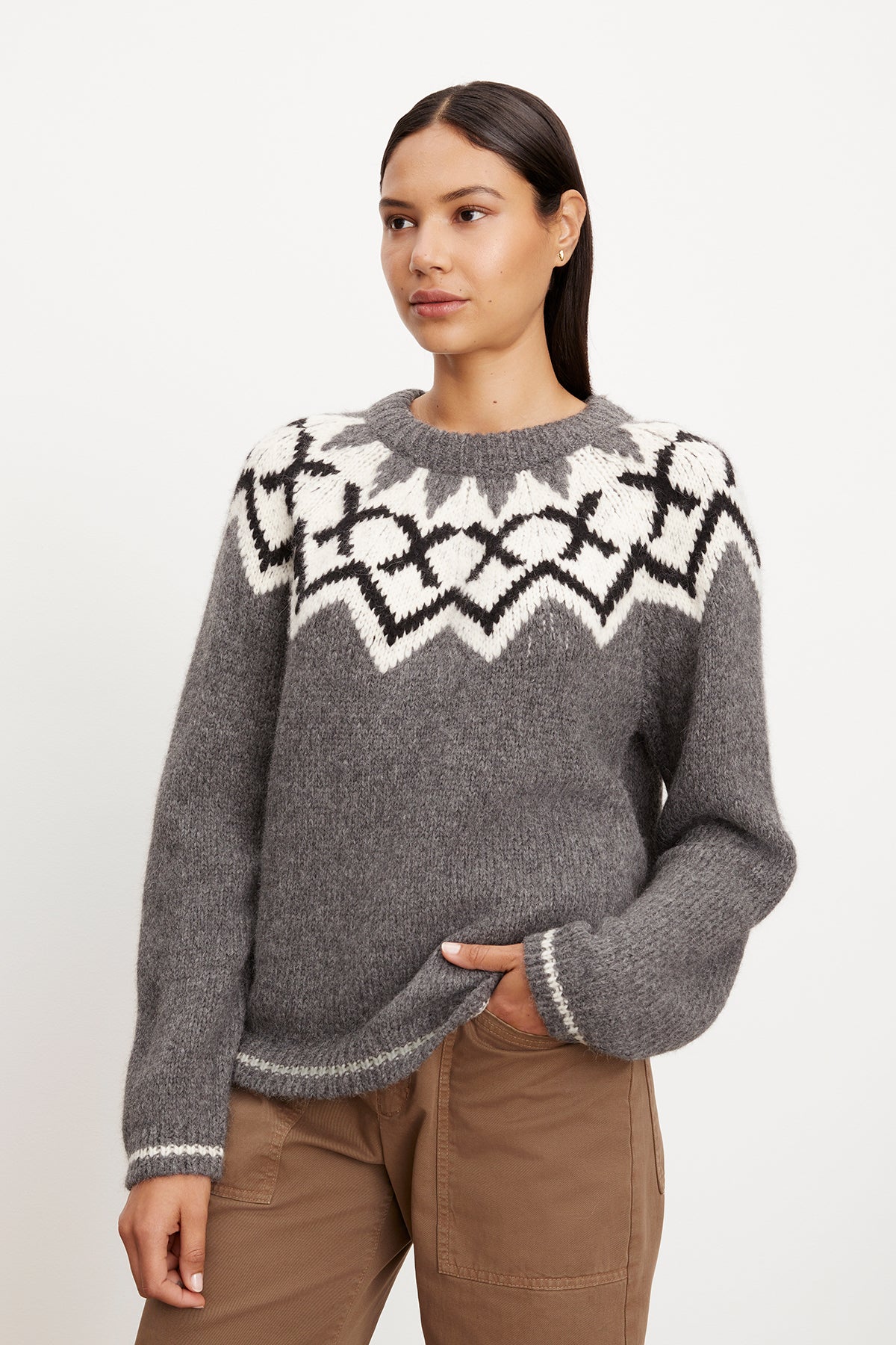 A woman wearing a Velvet by Graham & Spencer ALEXA FAIR ISLE CREW NECK SWEATER with a fair isle design pattern.-35572030243009