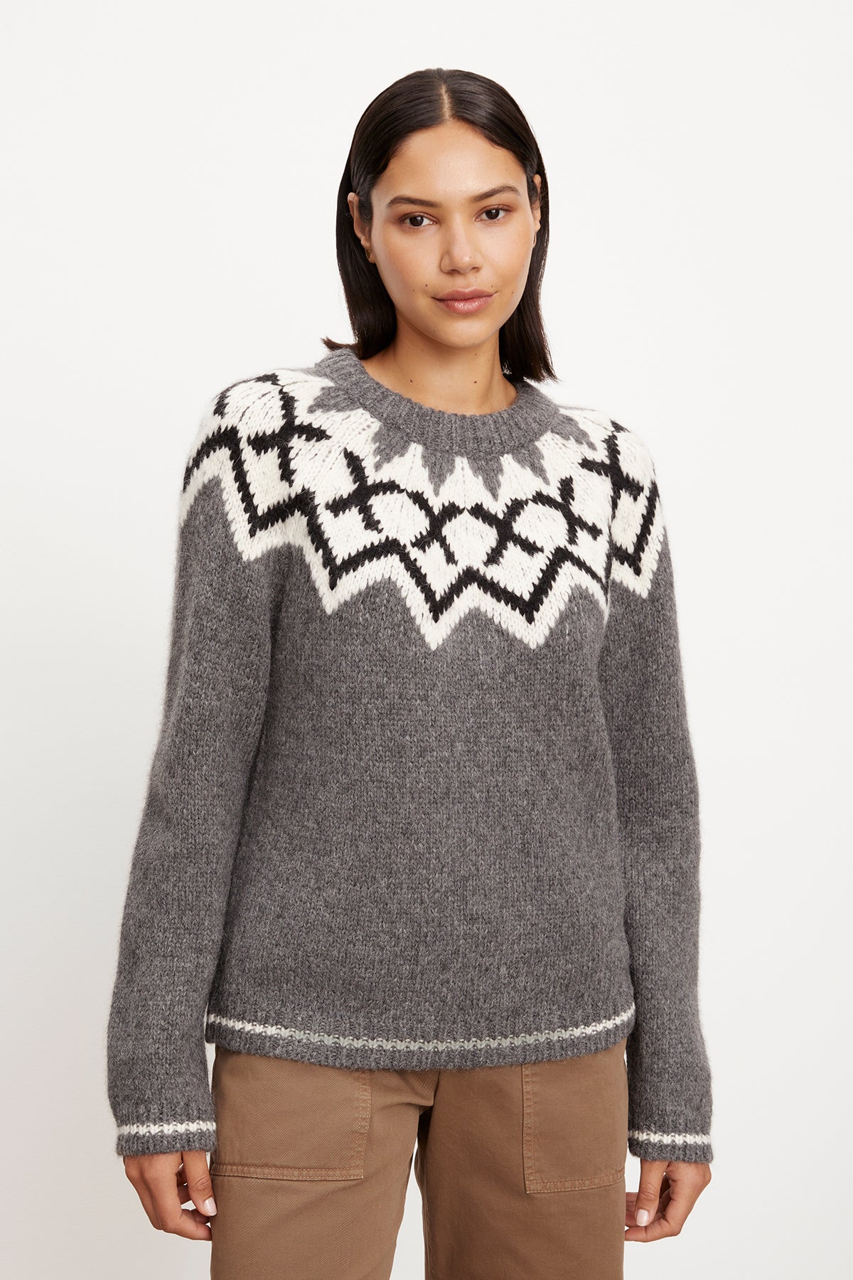 A woman wearing an Alexa Fair Isle Crew Neck sweater by Velvet by Graham & Spencer.-35572030177473