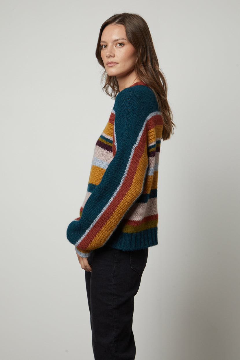 The model is wearing a SAMARA STRIPED CREW NECK SWEATER from Velvet by Graham & Spencer.