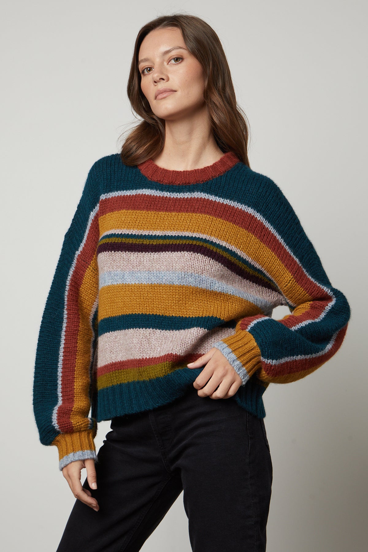 A woman wearing a cozy and elegant Velvet by Graham & Spencer SAMARA STRIPED CREW NECK SWEATER.-35650106687681