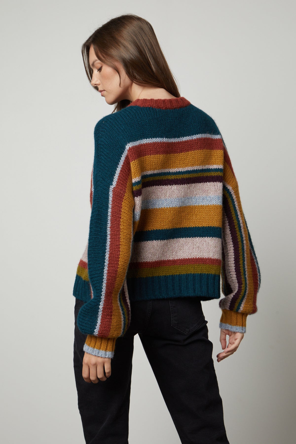 The back view of a woman wearing a Velvet by Graham & Spencer SAMARA STRIPED CREW NECK SWEATER.-26897840341185