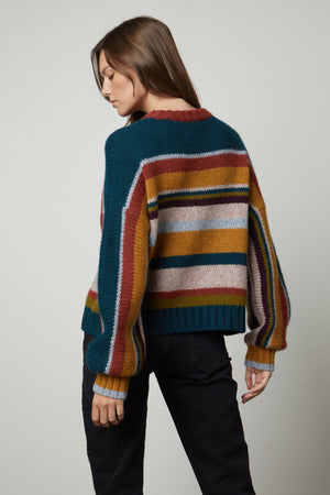 The back view of a woman wearing a Velvet by Graham & Spencer SAMARA STRIPED CREW NECK SWEATER.