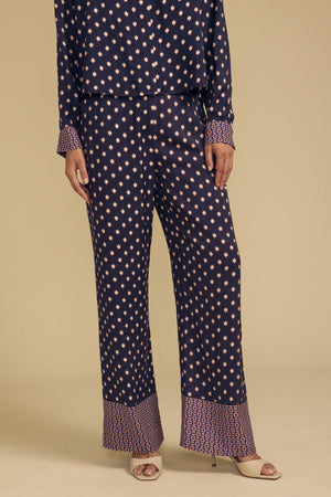 Velvet by Graham & Spencer CAROL PRINTED PANT in navy blue viscose, featuring a peach-colored diamond pattern and a patterned border at the cuffs, perfect for a special occasion.