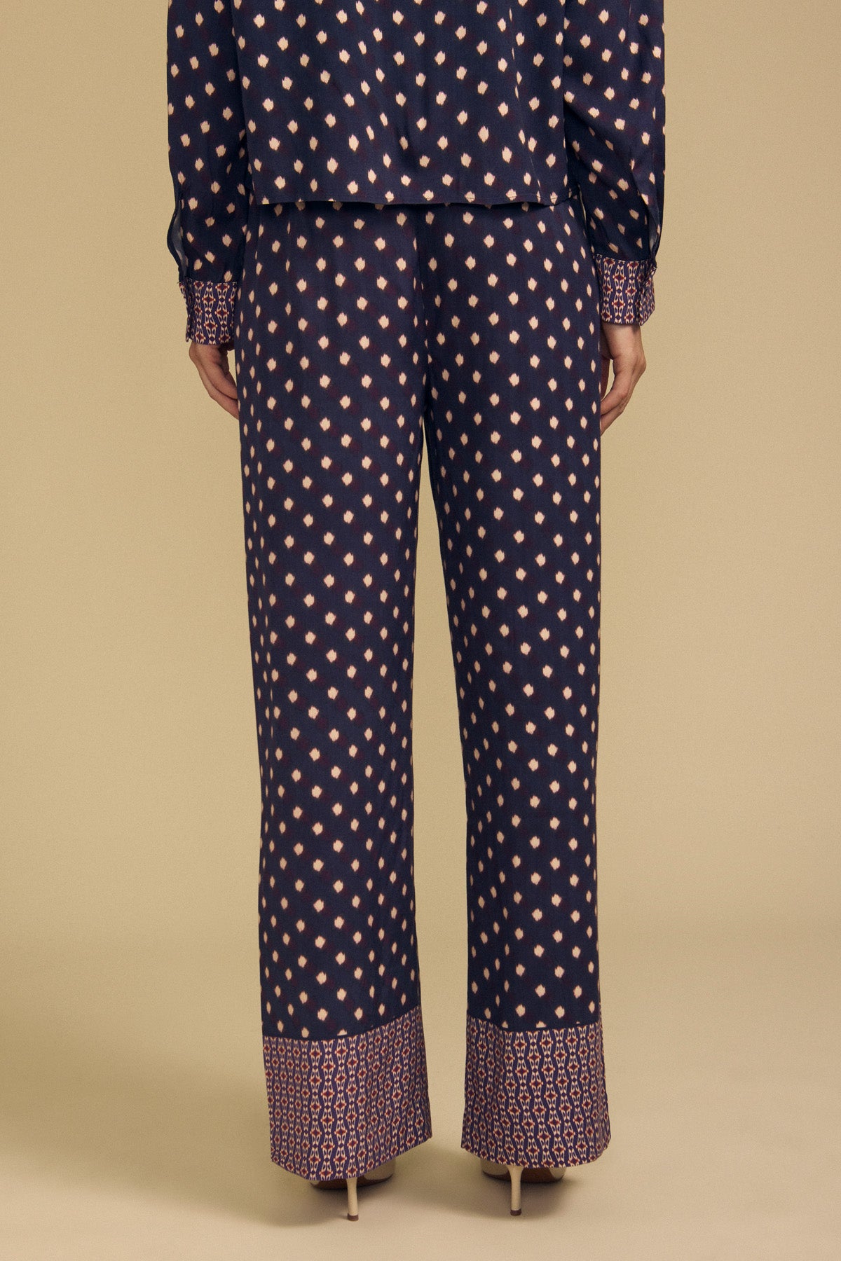 Velvet by Graham & Spencer CAROL PRINTED PANT in navy blue viscose, featuring a light-colored diamond pattern and a decorative geometric border at the hem.